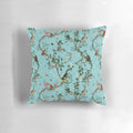 Colorful watercolor-style monkey and floral design on an aqua blue decorative pillow