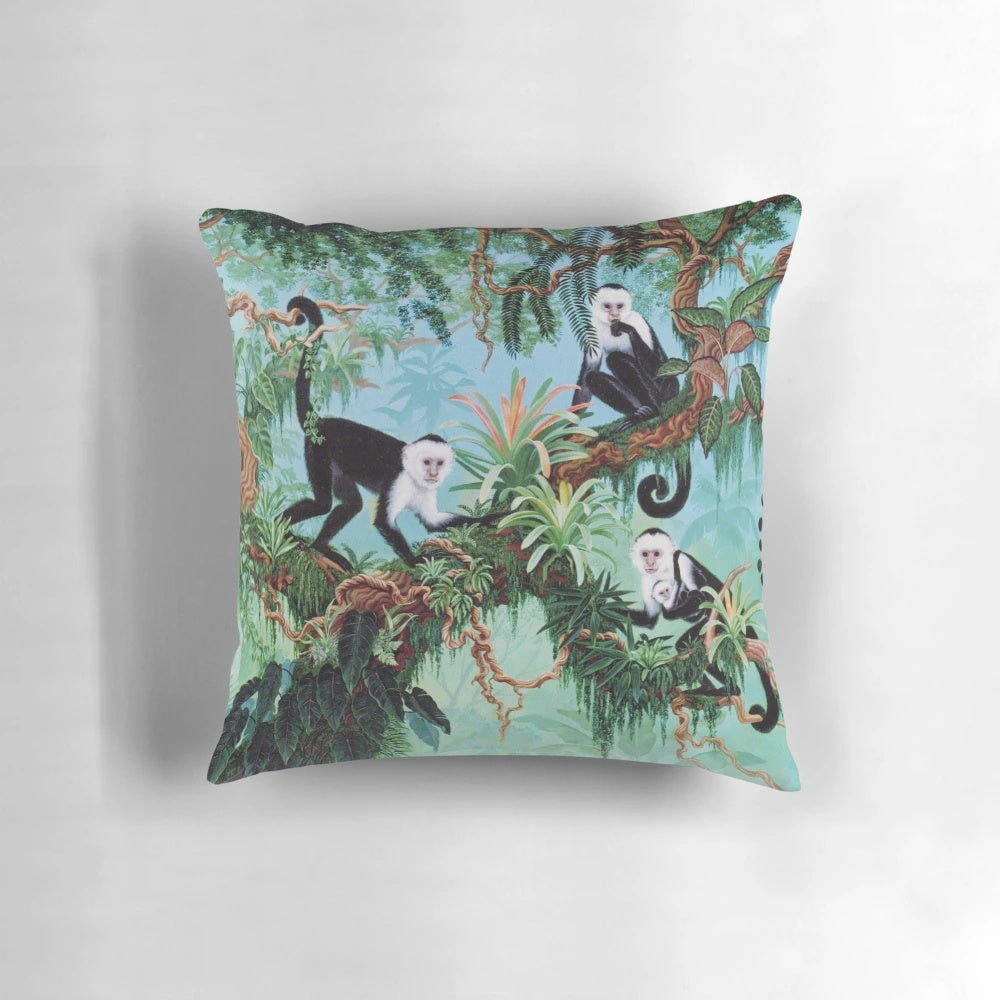 Vibrant monkey-themed pillow with tropical jungle design by artist Jan Betts