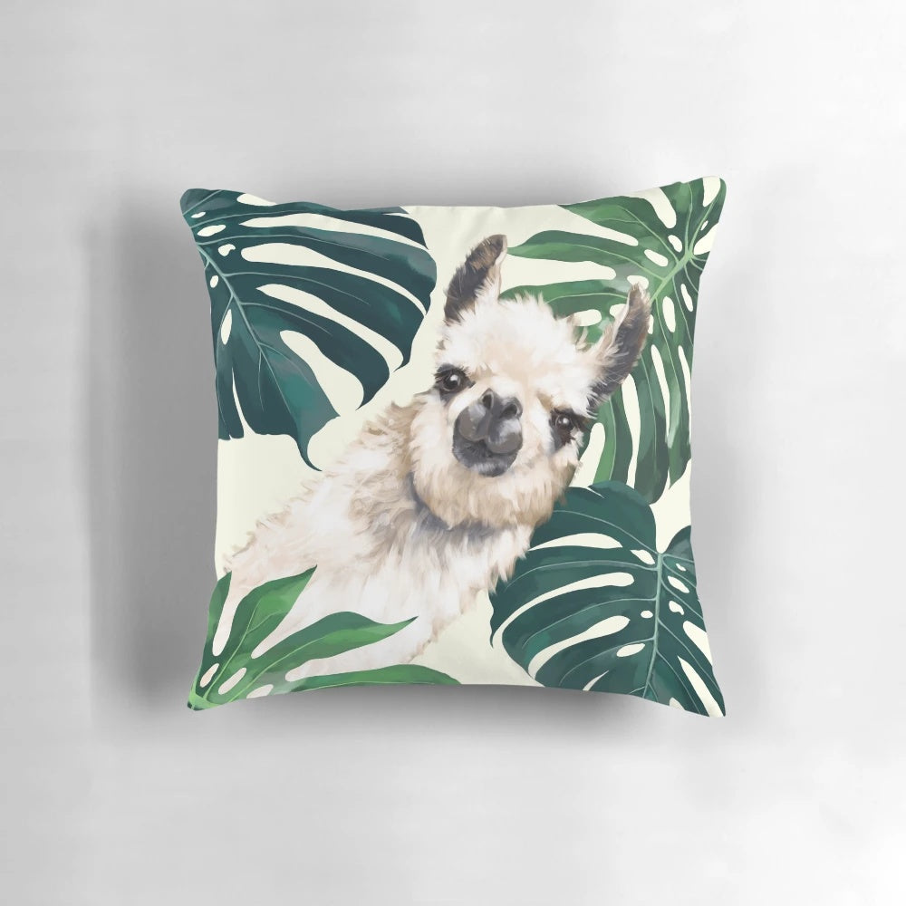 A plush, square accent pillow featuring a tropical monstera leaf design and a playful llama meme print.