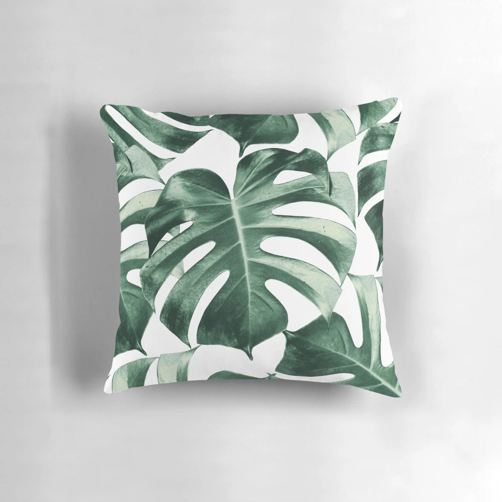 Vibrant tropical monstera leaves pattern on a decorative pillow