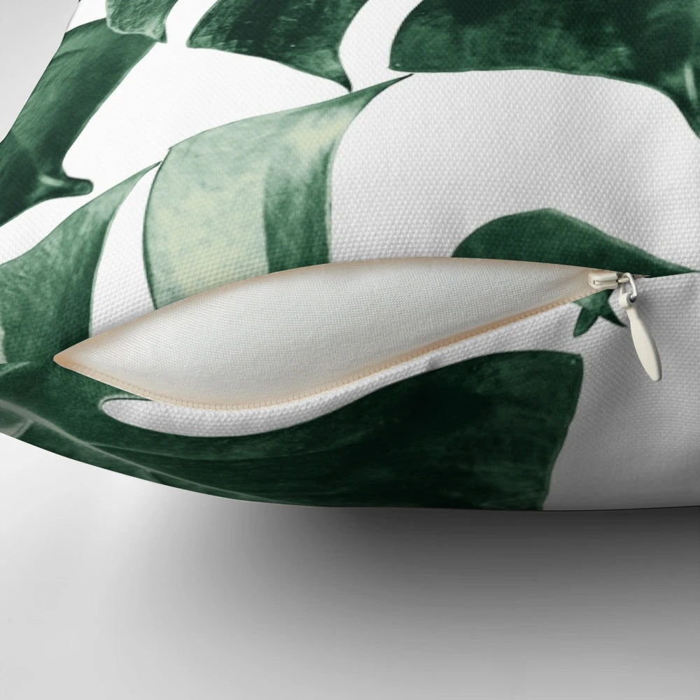 Vibrant tropical monstera leaves pattern on a decorative pillow