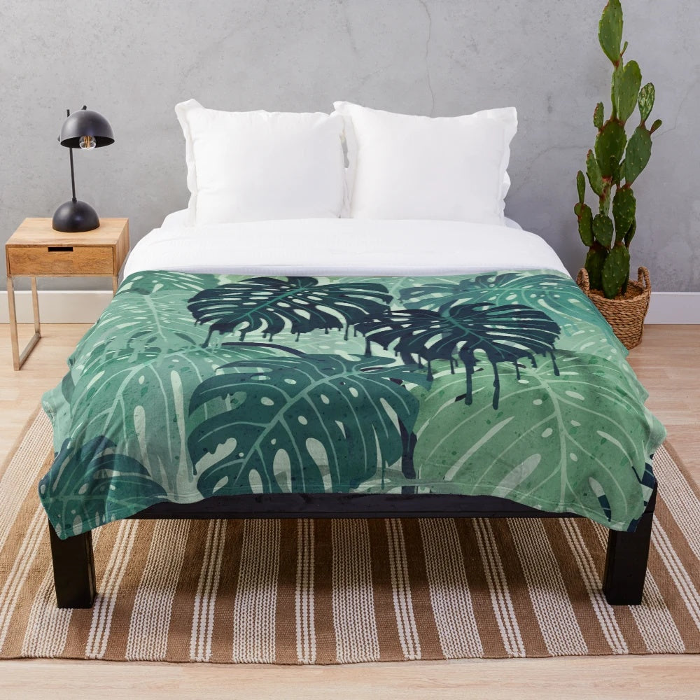 Plush monstera leaf blanket in a surreal, tropical design