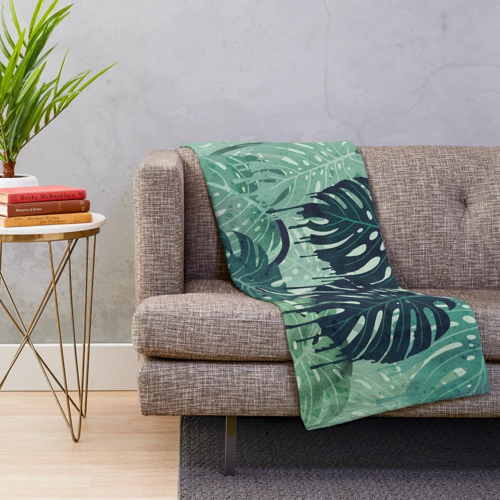 Plush monstera leaf blanket in a surreal, tropical design