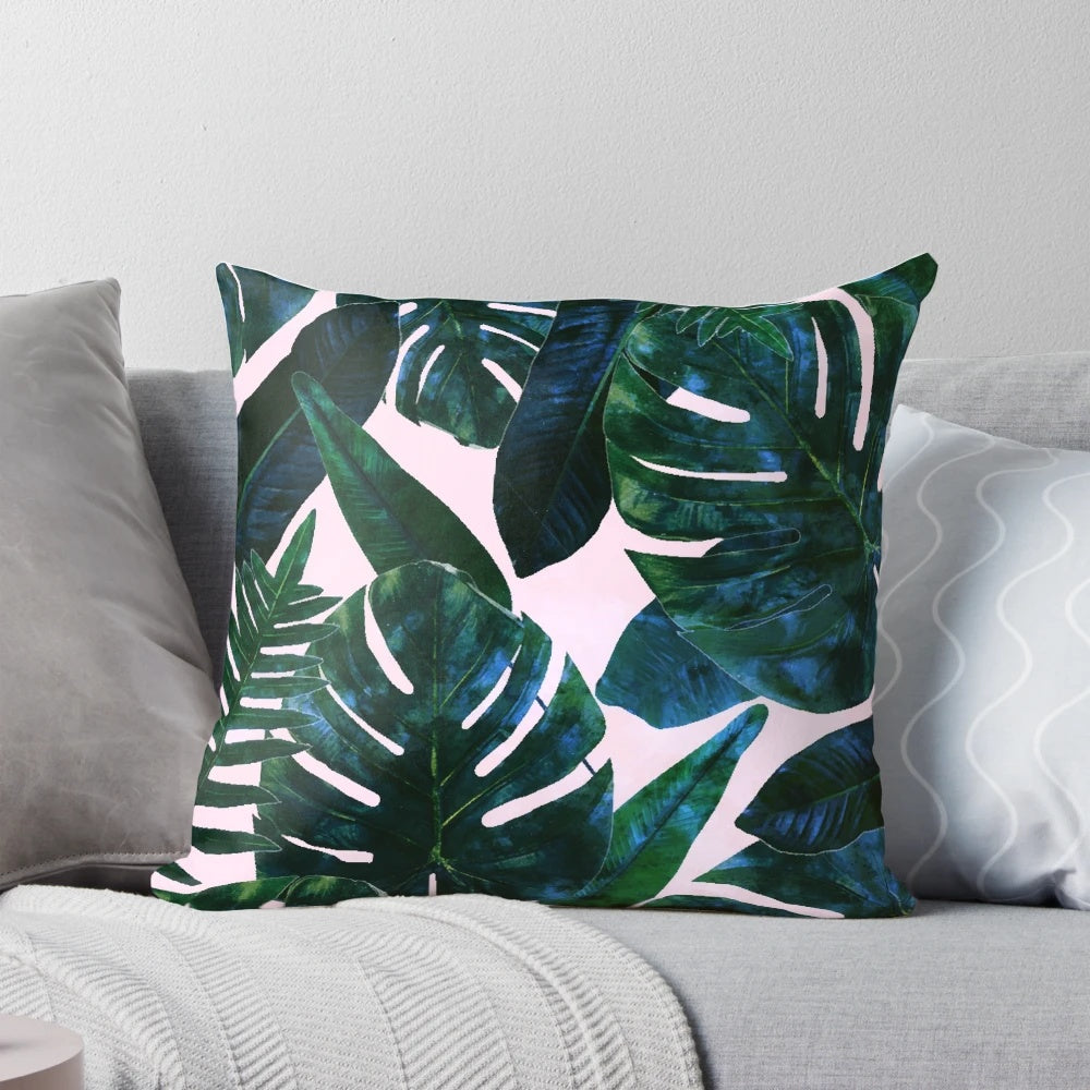 Tropical botanical plants painting featuring palm, monstera, and banana leaves in a lush jungle setting, printed on a decorative pillow.
