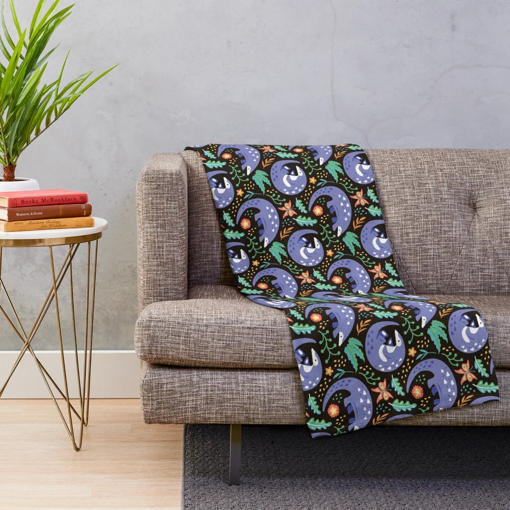 Pangolin pattern plush blanket with tropical leaves, plants, and butterflies