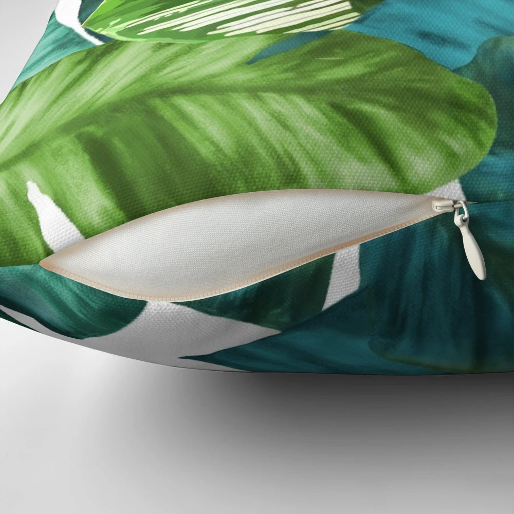 Vibrant tropical parrot design with banana leaves on a pillow