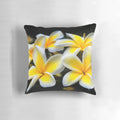 Vibrant yellow plumeria or frangipani flowers on a tropical floral pillow