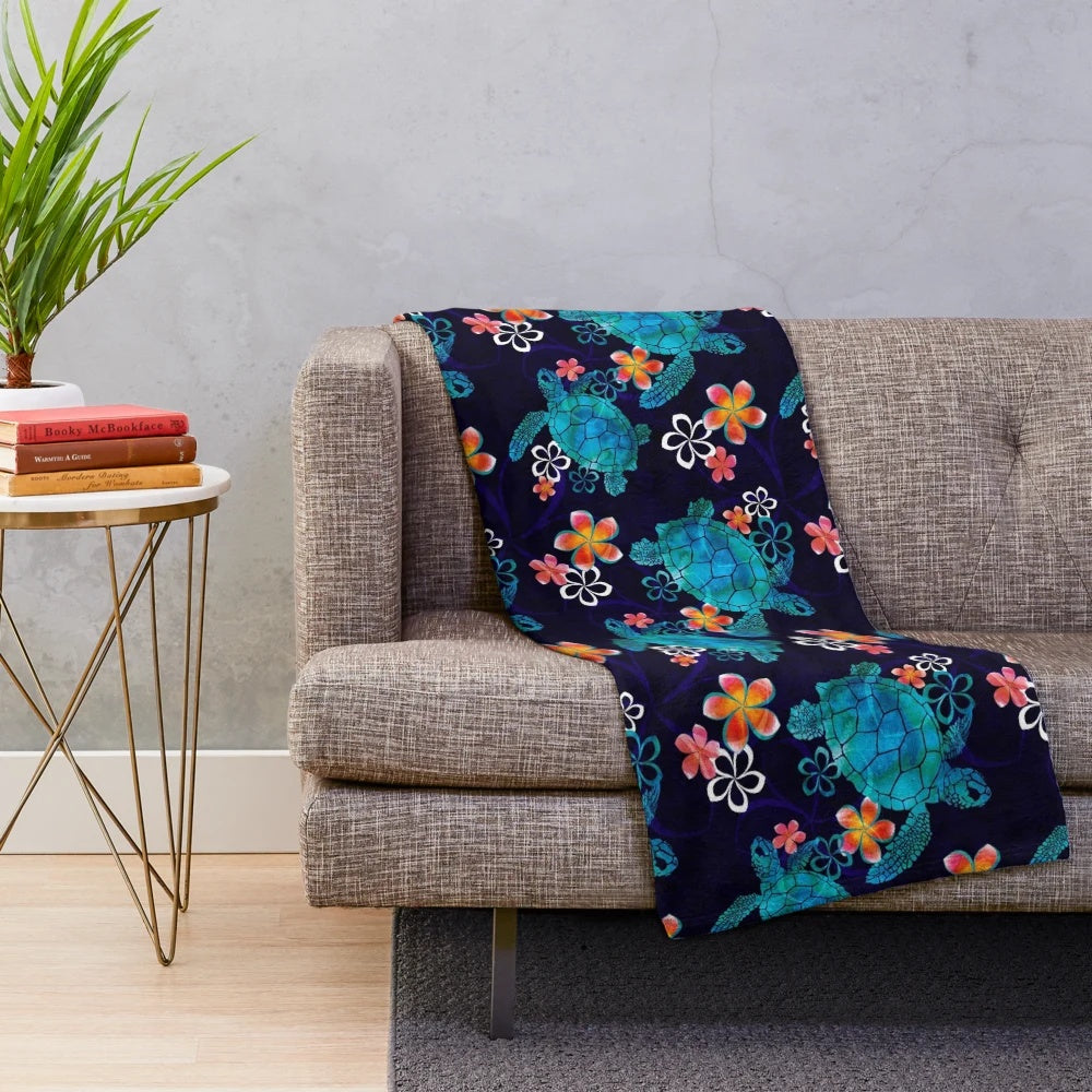 Plush blanket featuring a sea turtle design with tropical flowers