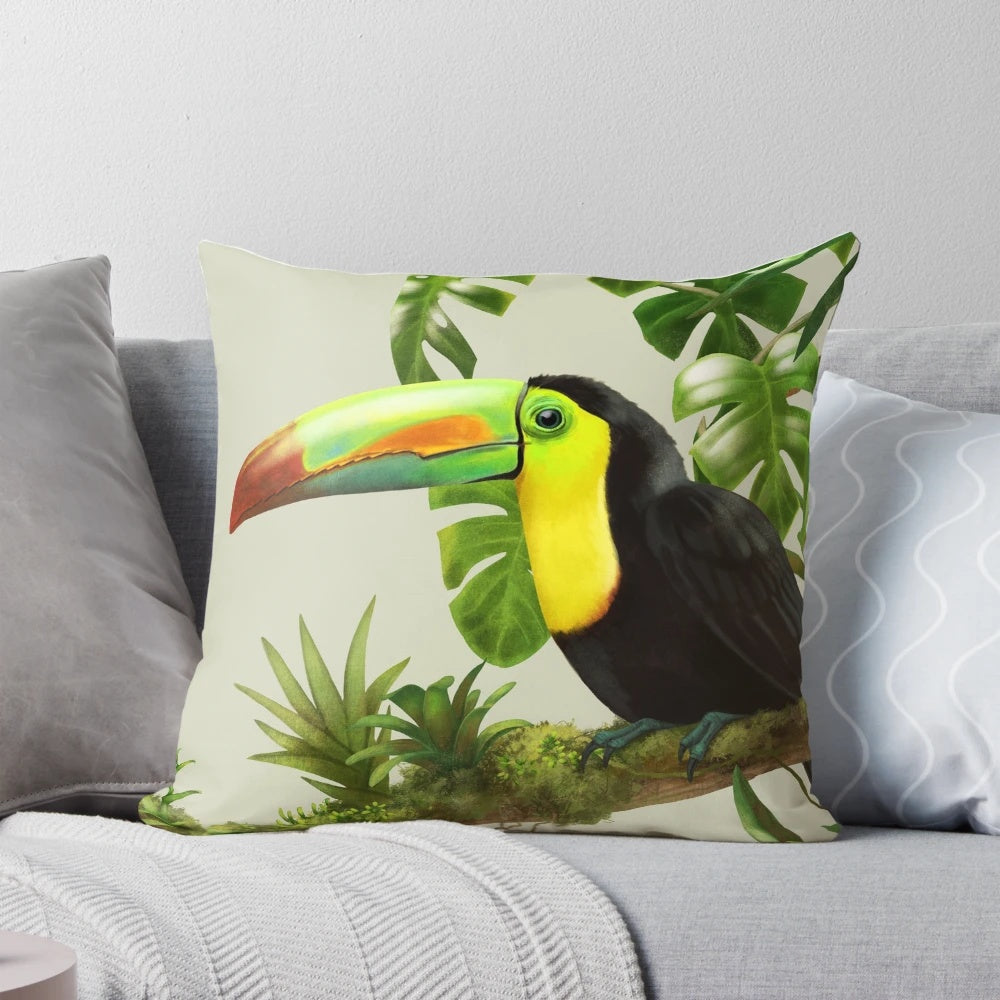 A decorative throw pillow featuring a vibrant illustration of a toco toucan perched on a bromeliad plant against a lush, green background.