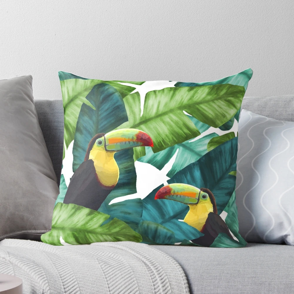 Tropical pillow with a colorful pattern featuring toucans and banana leaves