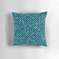 Turquoise blue pillow with mermaid scales pattern, perfect for adding a touch of the ocean to your home.