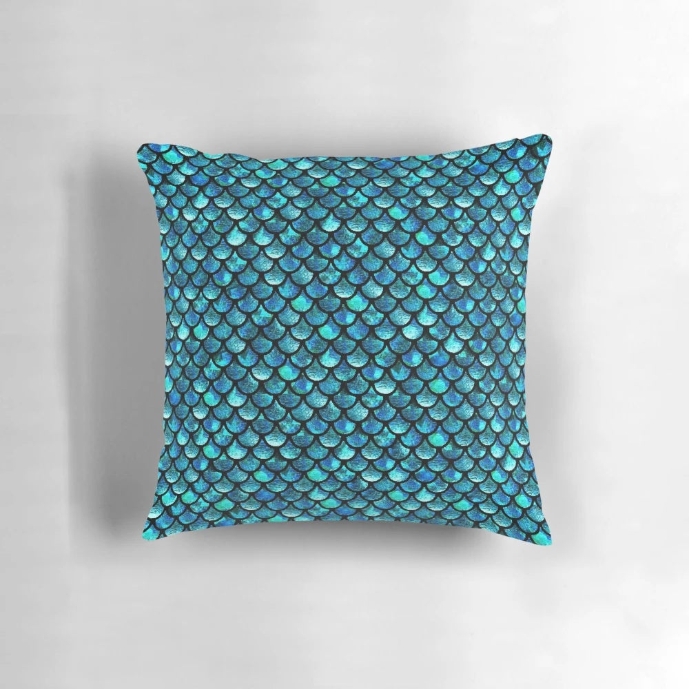 Turquoise blue pillow with mermaid scales pattern, perfect for adding a touch of the ocean to your home.