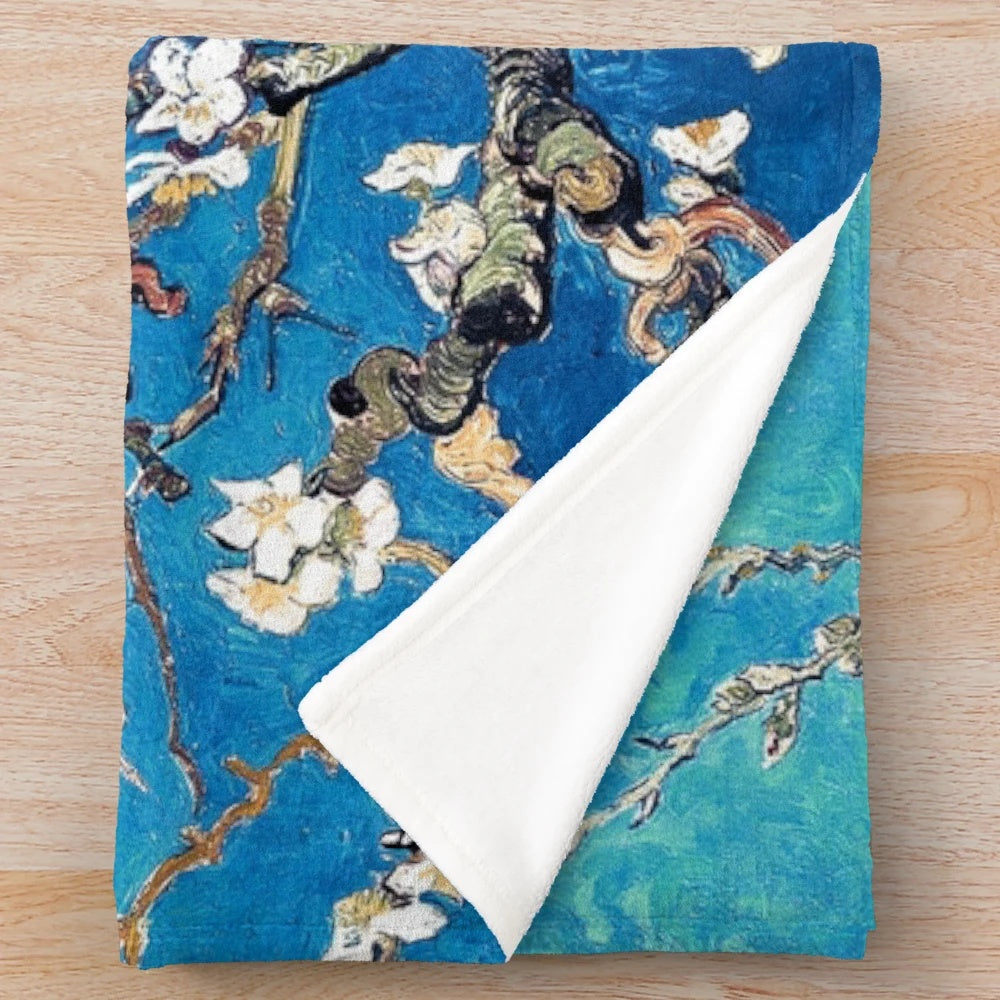 Turquoise plush blanket featuring a vincent van gogh inspired almond blossom floral design