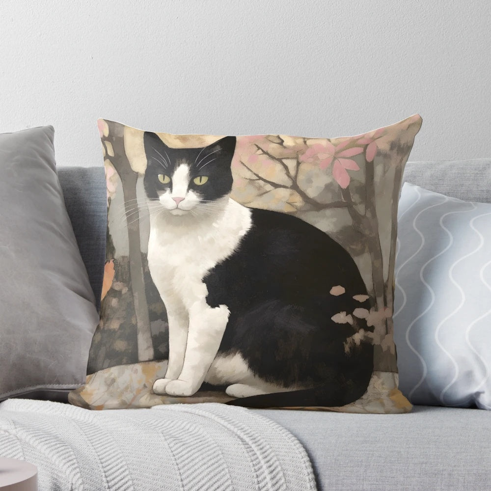 Soft, watercolor-style pillow featuring a tuxedo cat perched on a rock in a forested setting