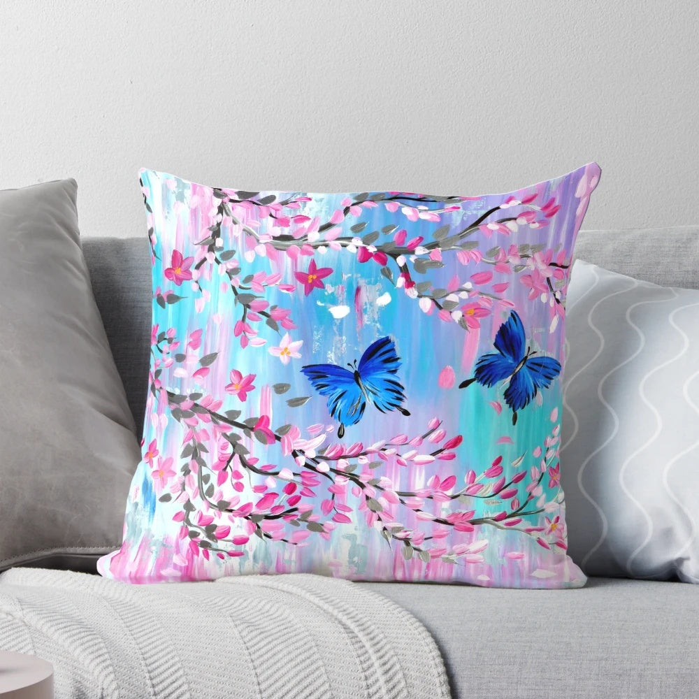 Vibrant blue Ulysses butterflies fluttering amidst delicate Japanese cherry blossoms on a soft pillow cover.