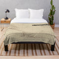 Uncharted map inspired plush blanket with game character and logo elements