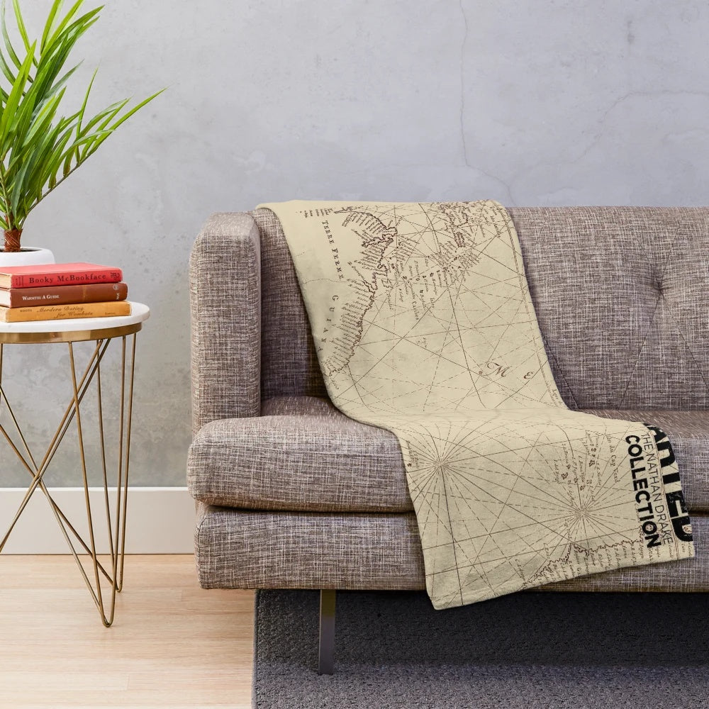 Uncharted map inspired plush blanket with game character and logo elements