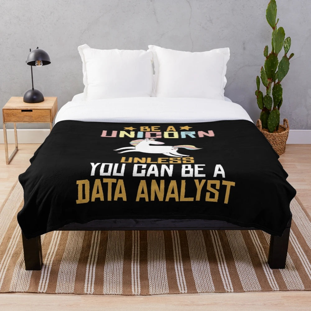 Plush blanket with a unicorn design and text "Be a unicorn unless you can be a data analyst