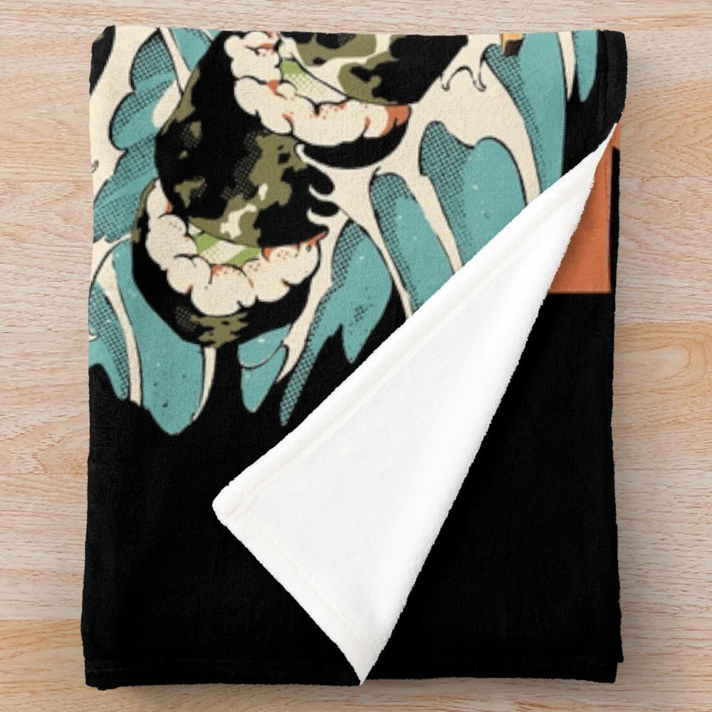 Plush blanket featuring a black and colorful anime-style monster with sushi, noodles, and waves