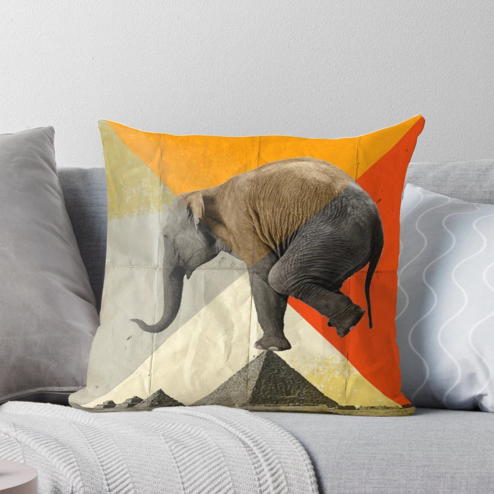 Decorative pillow featuring a graphic design of pyramids and an elephant in balance.