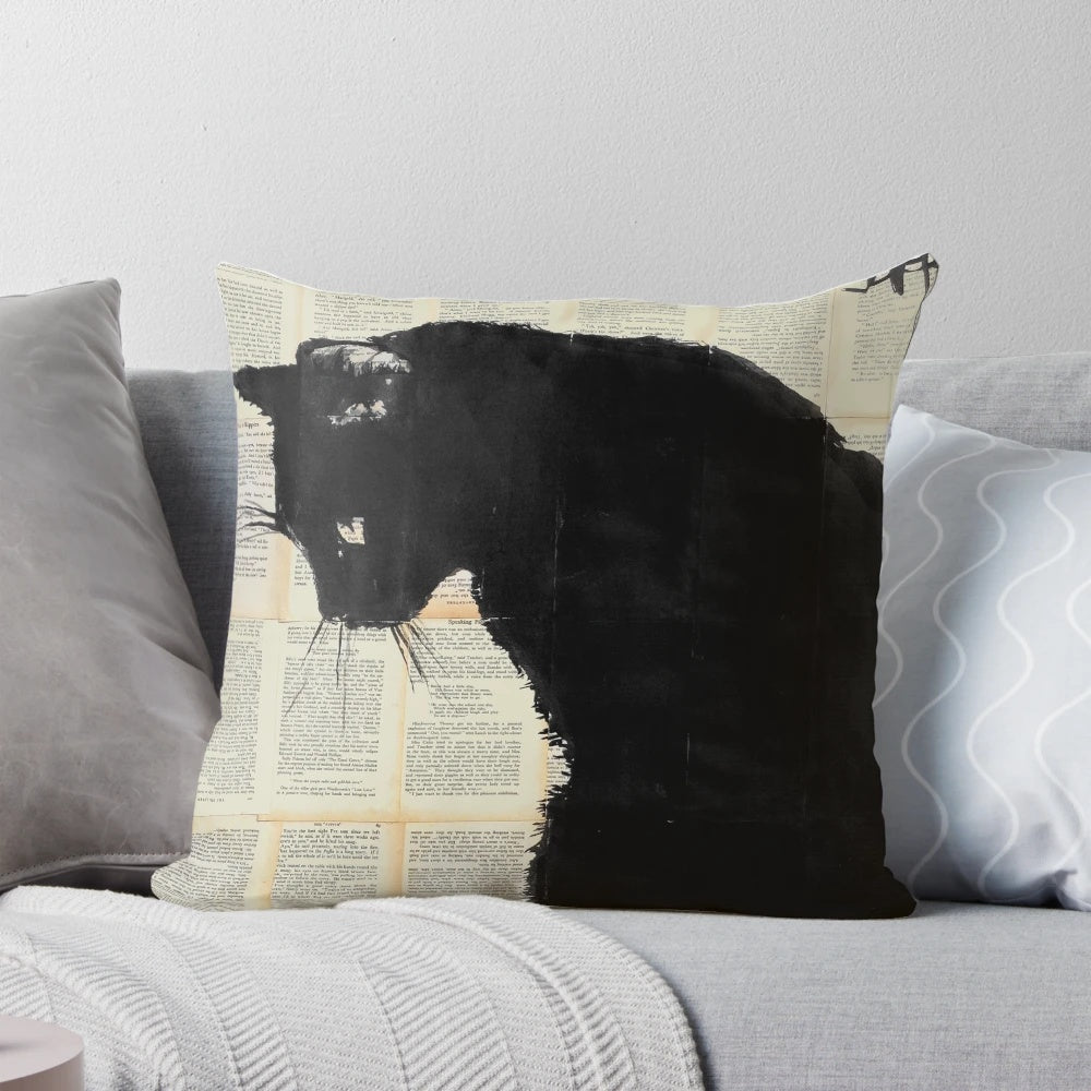 A decorative cat-themed throw pillow featuring a black and white ink drawing on book pages, inspired by the artwork of Loui Jover.