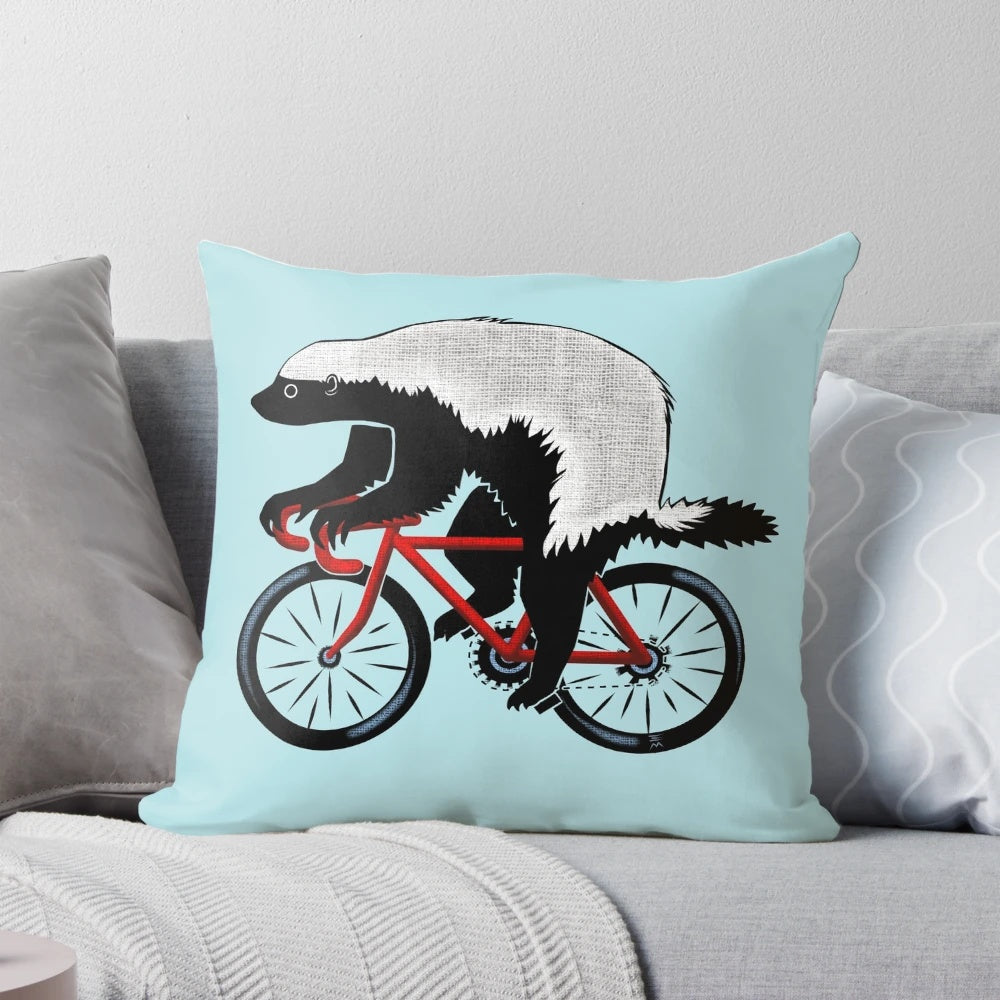 Honey badger riding a bicycle on a decorative throw pillow