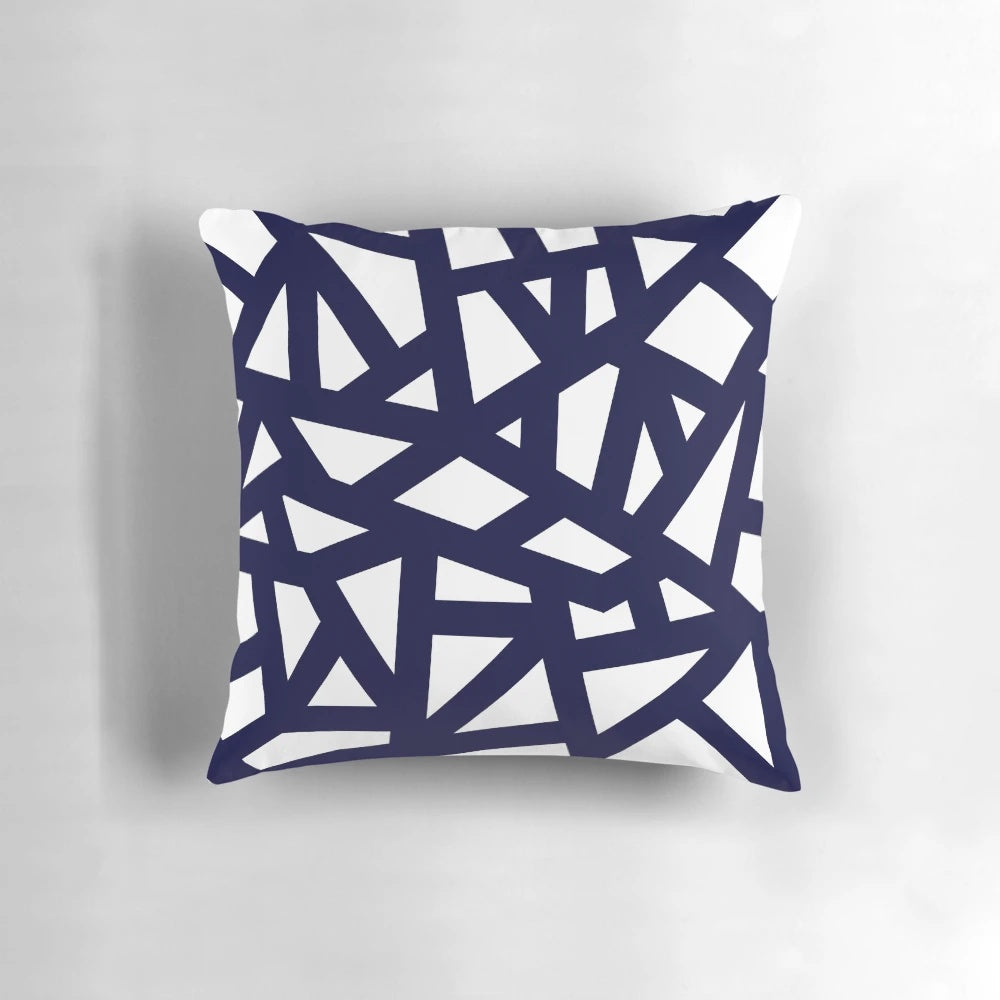 A navy blue decorative pillow with a geometric abstract pattern of intersecting lines and tiles