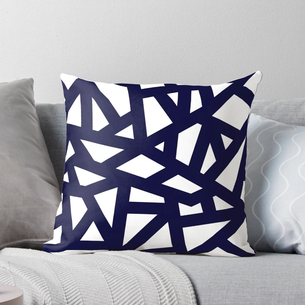 A navy blue decorative pillow with a geometric abstract pattern of intersecting lines and tiles