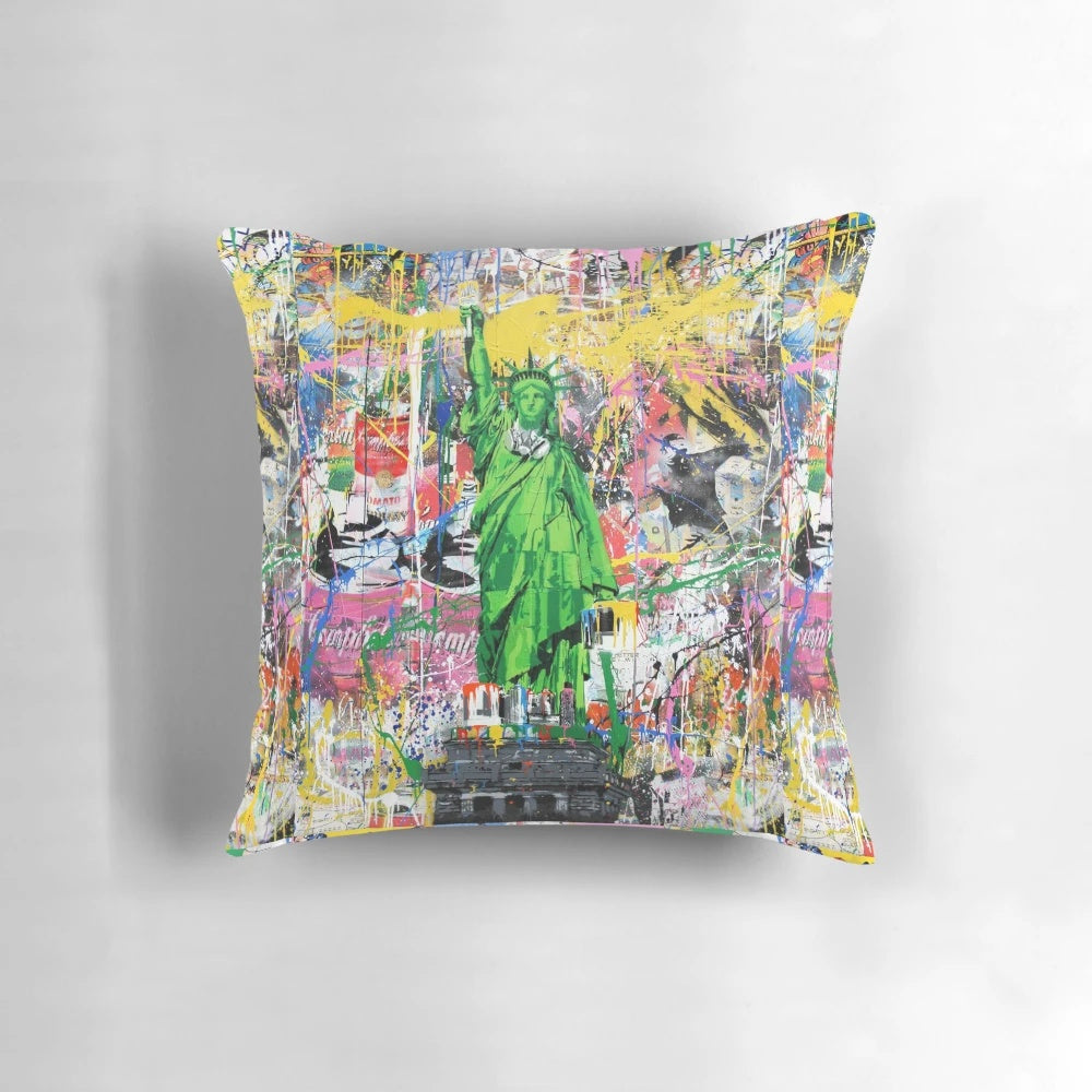 Vibrant pop culture-inspired pillow featuring a Banksy-style mashup of the Statue of Liberty holding a paintbrush.