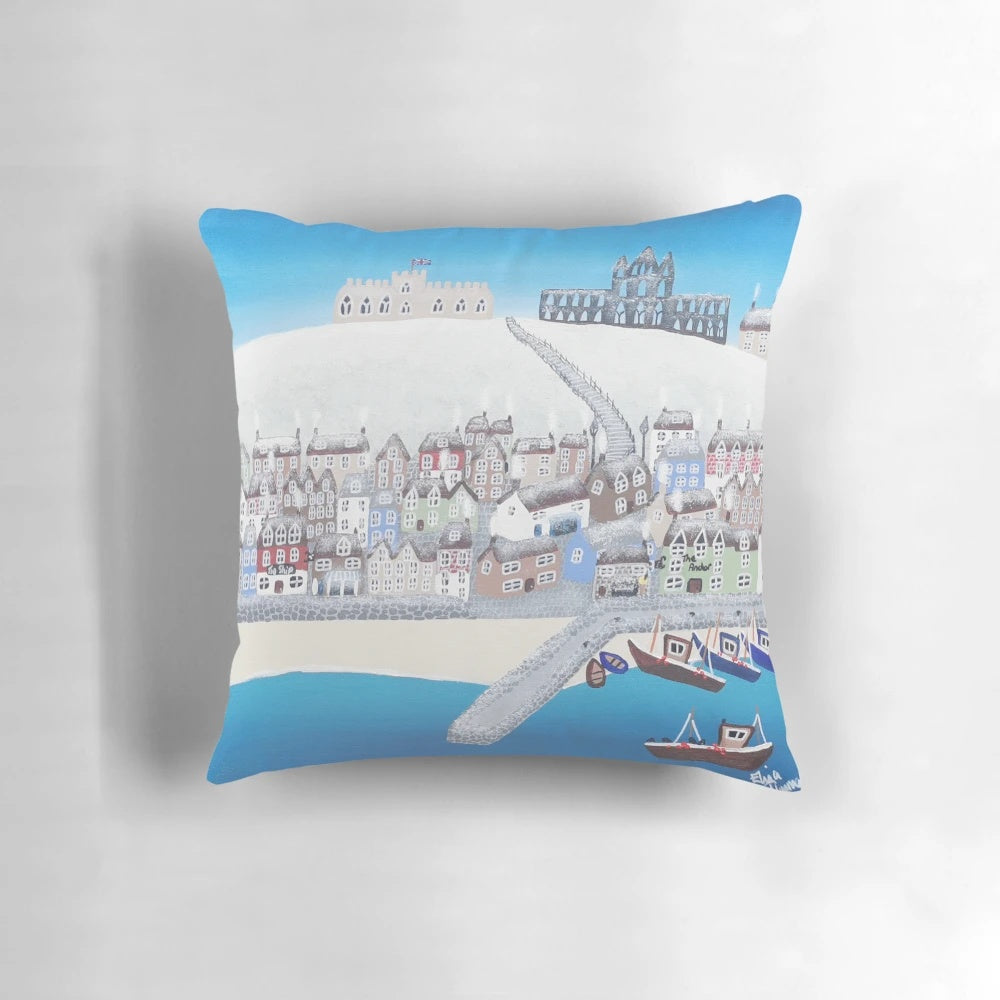 A contemporary art-inspired pillow featuring a wintery scene of Whitby, Yorkshire with the iconic abbey, boats, and snow-covered beach.