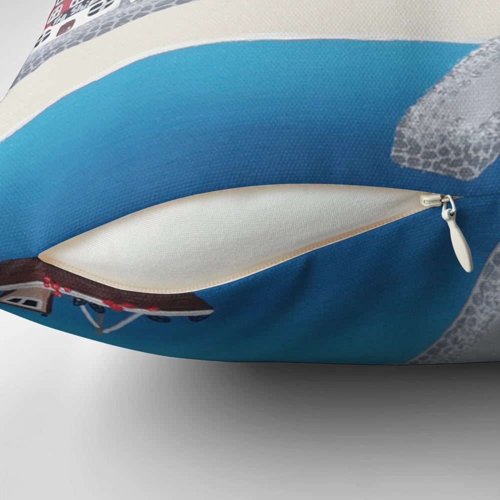 A contemporary art-inspired pillow featuring a wintery scene of Whitby, Yorkshire with the iconic abbey, boats, and snow-covered beach.
