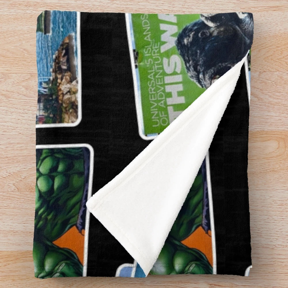 Universal Islands of Adventure-inspired plush blanket featuring a collage of iconic attractions