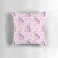 A pastel pink pillow with a playful dinosaur-like monster character and the text "First coffee then I destroy" printed on it.