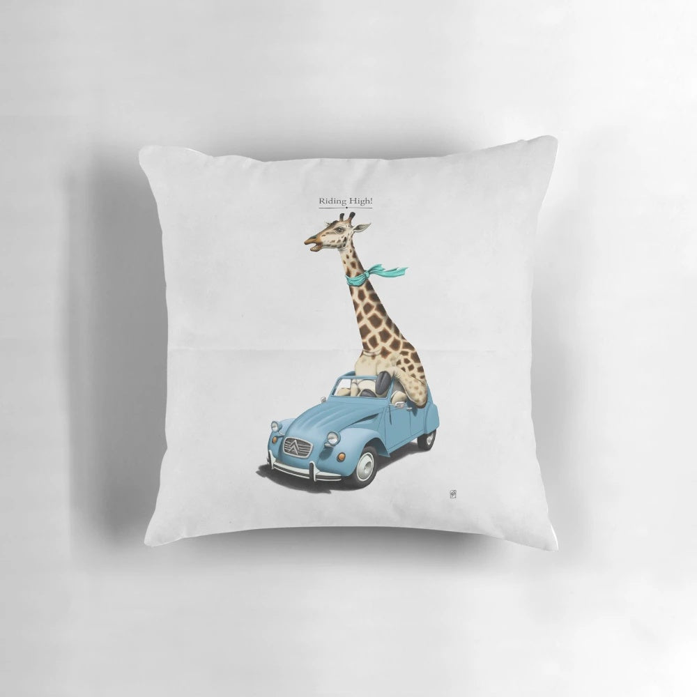 A colorful and imaginative pillow featuring a giraffe driving a vintage Citroen 2CV car, surrounded by nature and sketches.