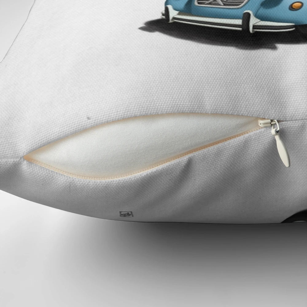 A colorful and imaginative pillow featuring a giraffe driving a vintage Citroen 2CV car, surrounded by nature and sketches.