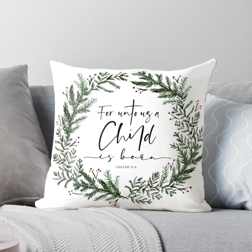 Pine wreath pillow with "Unto Us a Child is Born" bible verse text