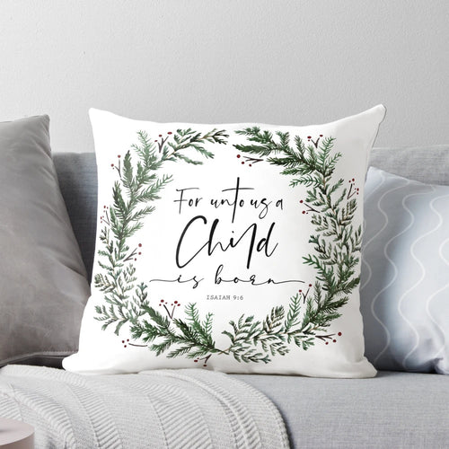 Pine wreath pillow with "Unto Us a Child is Born" bible verse text