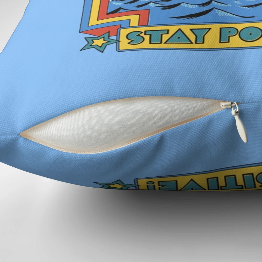 Decorative pillow with the text "Stay Positive" against a vibrant, retro-inspired background.