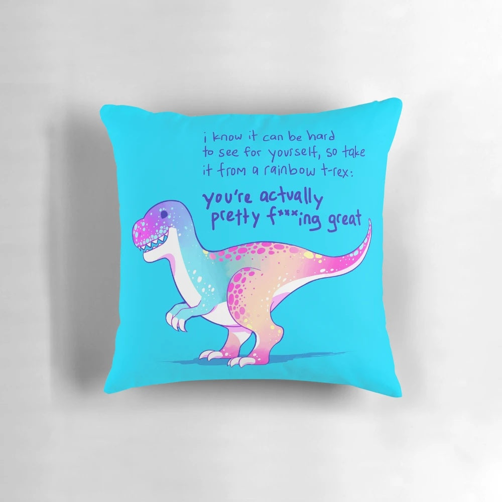 A vibrant, pastel-colored pillow featuring an illustrated t-rex dinosaur with an empowering message of self-acceptance and mental health.