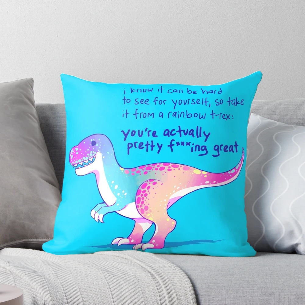 A vibrant, pastel-colored pillow featuring an illustrated t-rex dinosaur with an empowering message of self-acceptance and mental health.