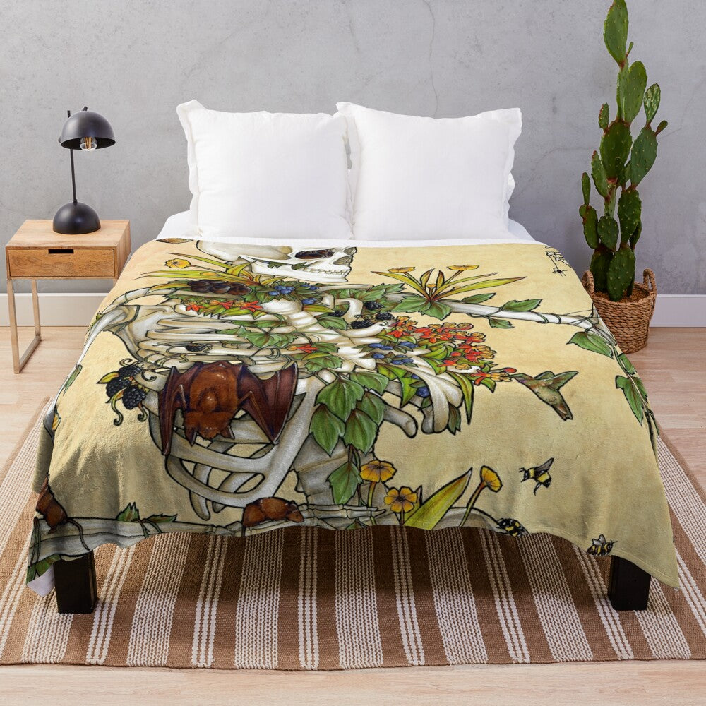 Plush blanket featuring a skeleton design with botanical elements including flowers and plants