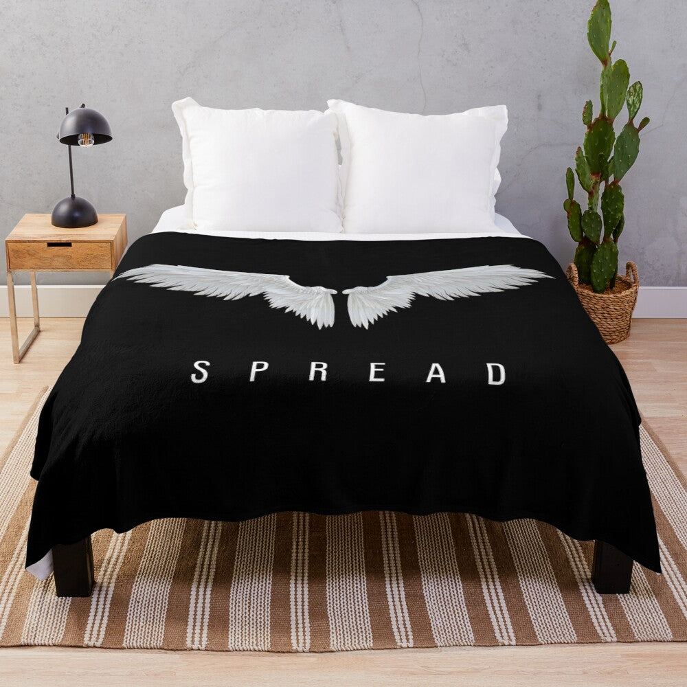 Plush blanket with typographic and wing graphic design