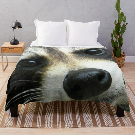 Soft and cozy plush blanket with a cute raccoon face design