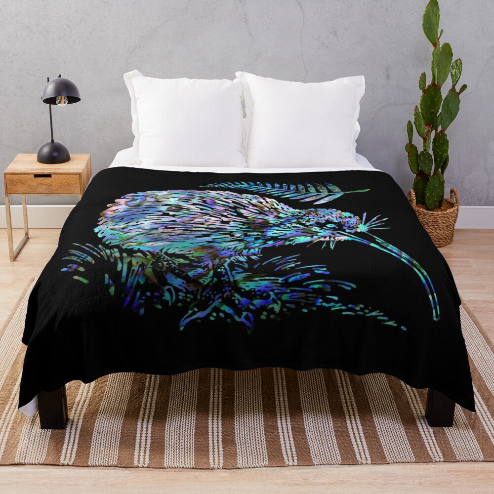 Colorful plush blanket featuring a paua shell design, kiwi, and ferns, representing the beauty of New Zealand