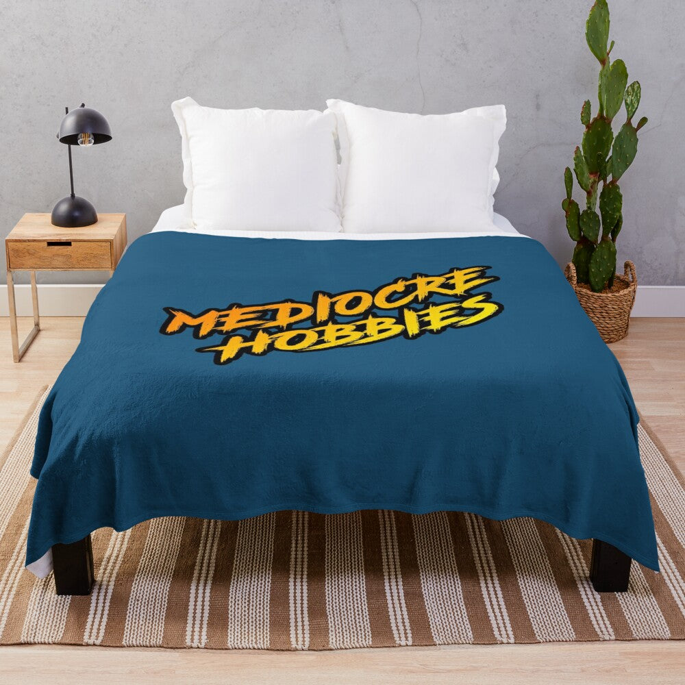 Plush blanket featuring the Mediocre Hobbies logo