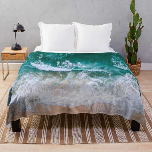 Plush blue blanket with serene ocean and beach imagery