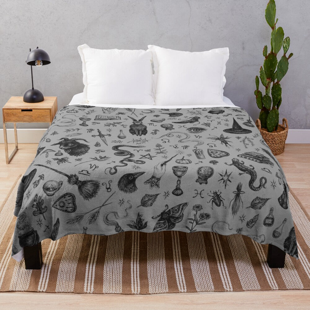 Salem witch plush blanket with rabbit, snake, and crow motifs