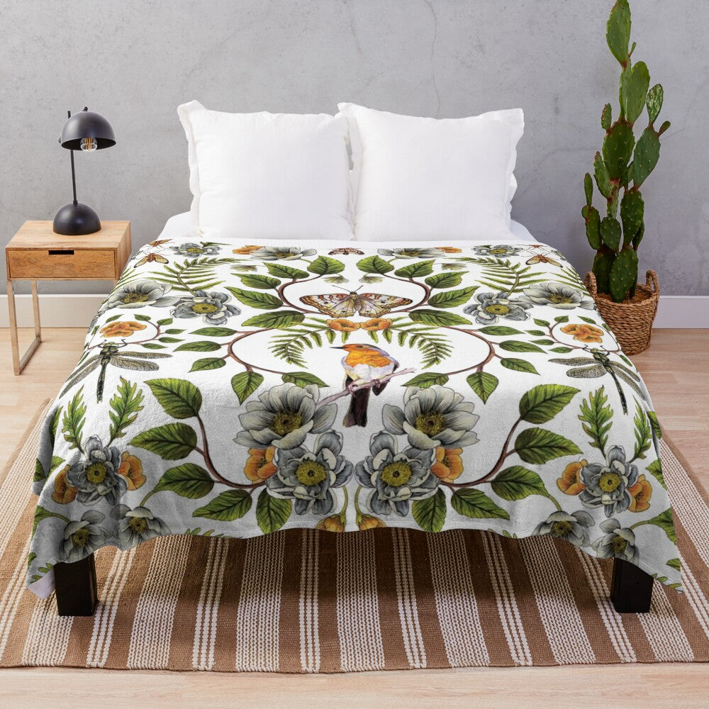 Floral plush blanket with botanical pattern featuring birds, moths, and dragonflies