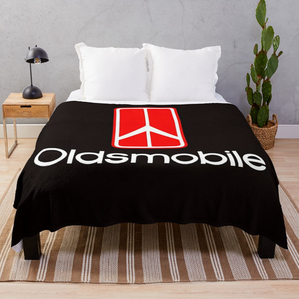 Oldsmobile logo printed on a soft, plush blanket