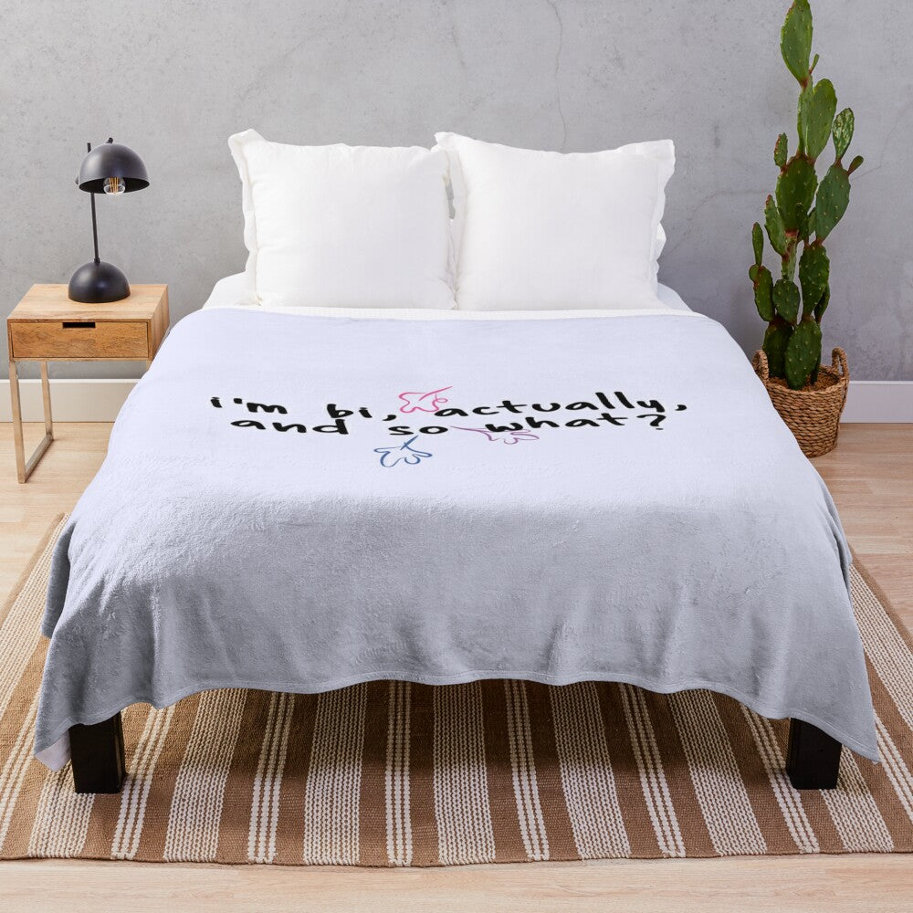 Soft plush blanket featuring the quote "i'm bi, actually, and so what?" from the Netflix series Heartstopper